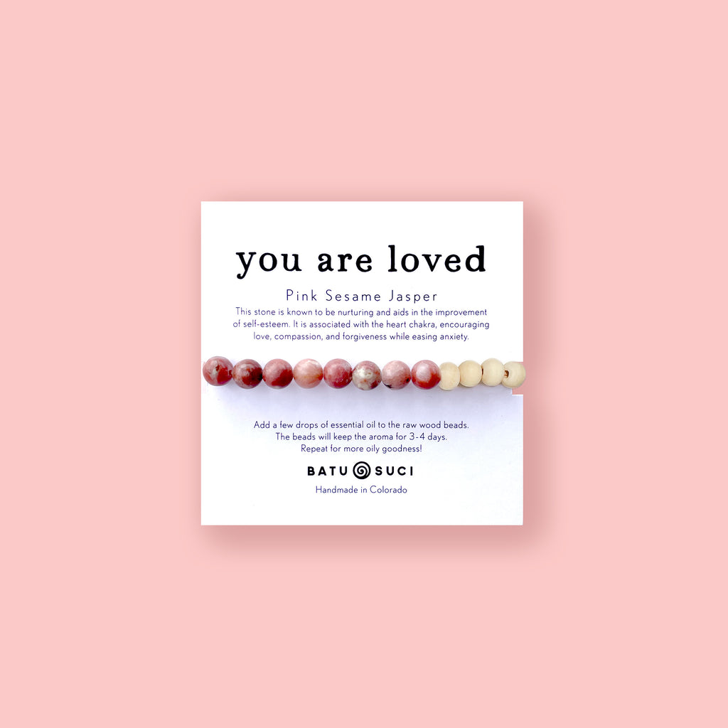 Diffuser bracelet with Pink Sesame Jasper beads and a You Are Loved informational card