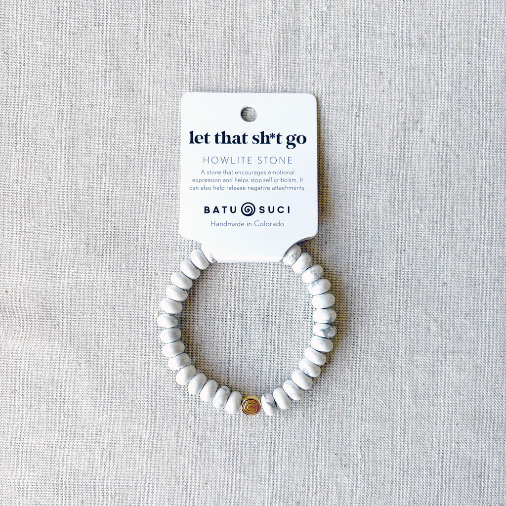 “Let That Shit Go” rondelle gemstone bracelet — handmade stress-relief jewelry from Batu Suci featuring smooth natural stones in calming neutral tones. Designed as a mindfulness reminder to release negativity and embrace peace. Lightweight, elastic, and perfect for everyday wear or meditation. Handcrafted in Colorado, this gemstone bracelet makes an empowering self-care gift for anyone needing to let go and move forward.