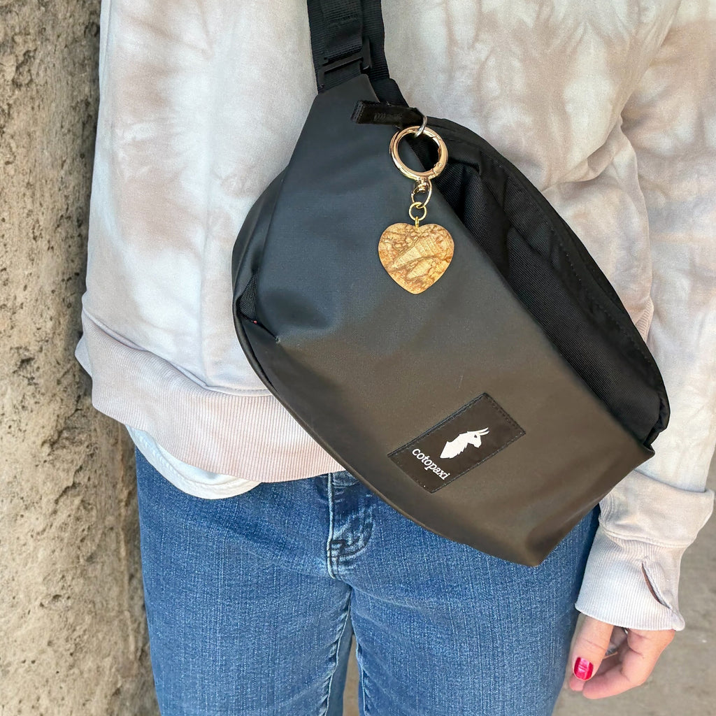Hand-carved Palo Santo Heart Bag Charm on gold-plated swivel clip keychain, sustainably sourced from Peru. Handmade in USA.